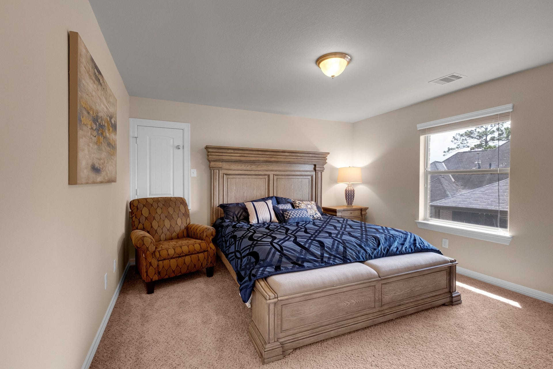 440 Old Orchard Court, Dickinson, TX 77539 A secondary bedroom sits carpeted and quiet with a window over the treetops - comfortable proportions and a full closet.