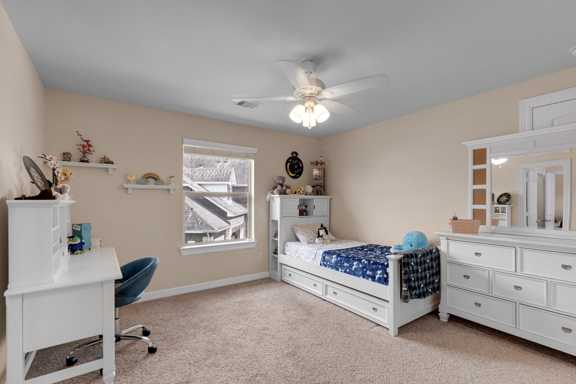 440 Old Orchard Court, Dickinson, TX 77539 This bedroom takes the corner light, with a ceiling fan, wall shelving, and space for a desk beside the closet.