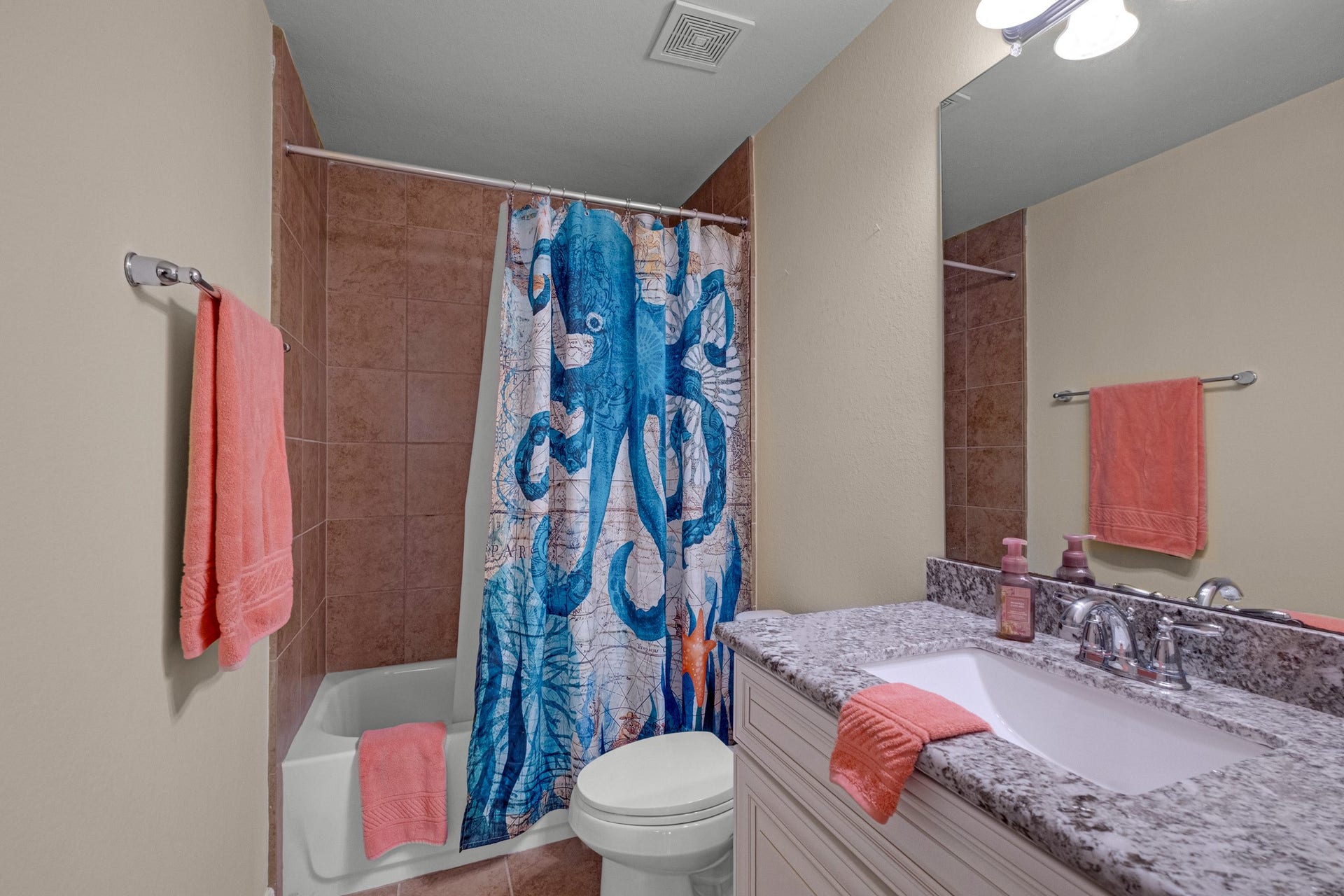 440 Old Orchard Court, Dickinson, TX 77539 An upstairs bath keeps things practical - tiled tub-shower surround, granite vanity, and a wide mirror over the sink.
