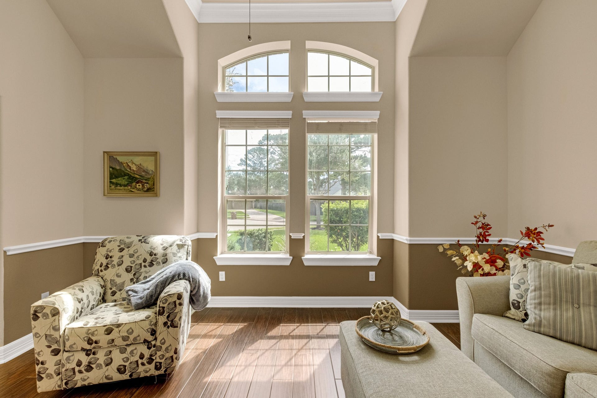 440 Old Orchard Court, Dickinson, TX 77539 Paired arched transoms crown double-hung windows here, filling the room with morning light and giving the front rooms their cathedral feel.