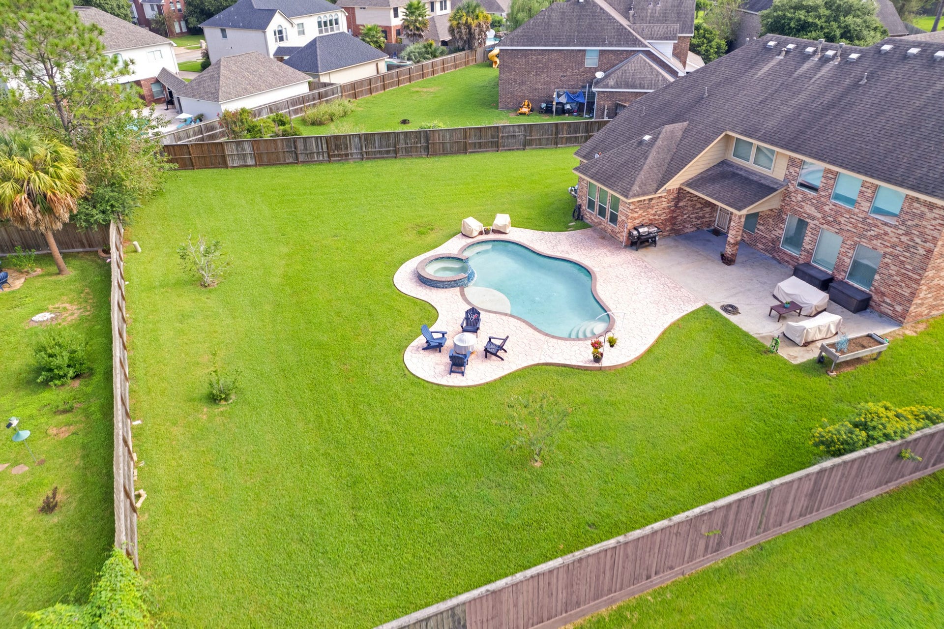 440 Old Orchard Court, Dickinson, TX 77539 From above, the pool and deck read as a single sculpted shape set into a deep, fully fenced half-acre lot with room to spare in every direction.
