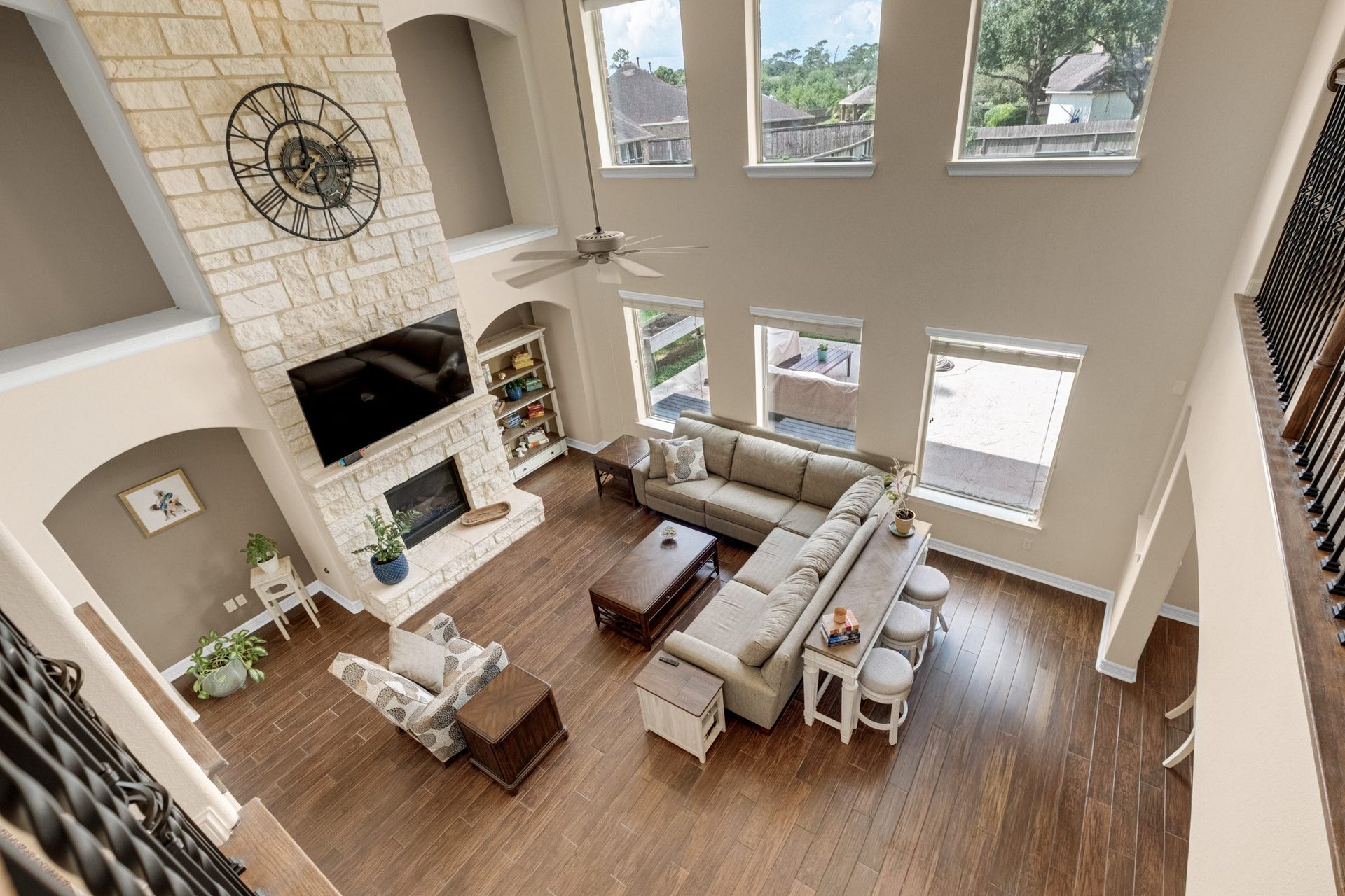440 Old Orchard Court, Dickinson, TX 77539 From the catwalk you get the best read on the volume - two full stories of stone chimney, stacked arched niches, and a window wall opening to the pool.