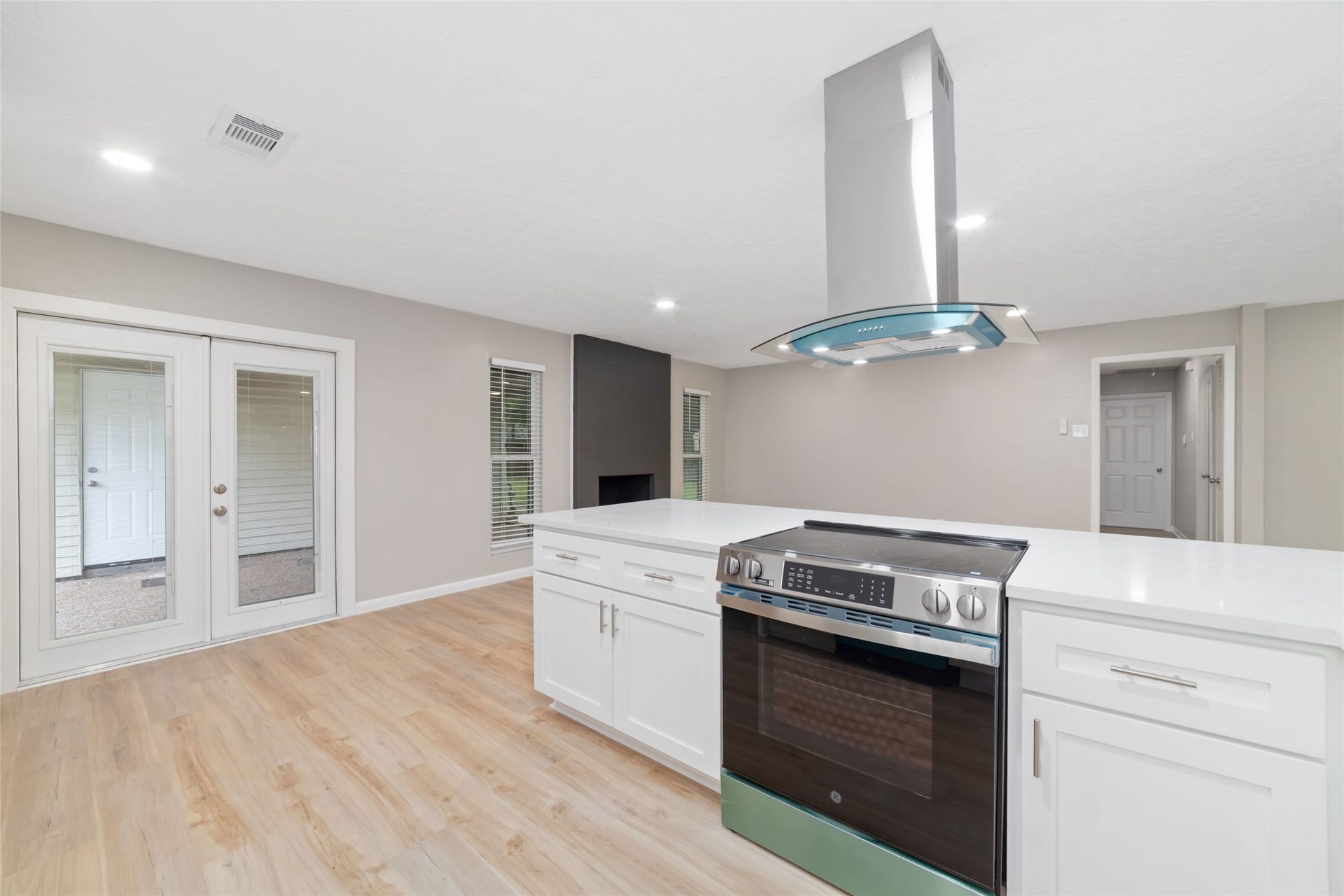 2830 Westerland Drive, Houston, TX 77063 A new stainless GE range with a smooth cooktop, a glass-and-stainless vent hood and quartz counters ready for your next dinner party.