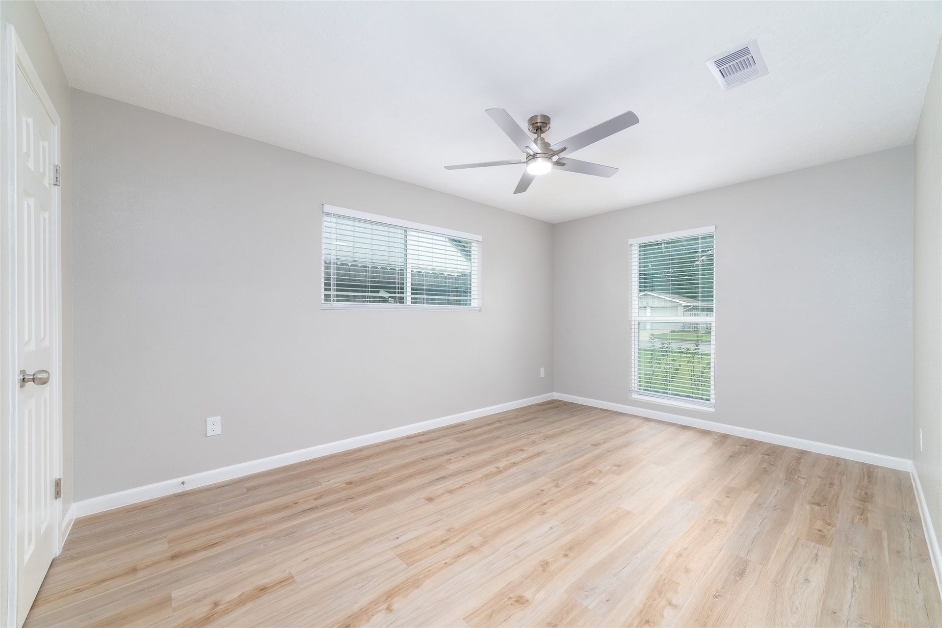 2830 Westerland Drive, Houston, TX 77063 Guest bedroom two catches the light from two directions, with new double-pane windows and faux wood blinds and spacious closet.