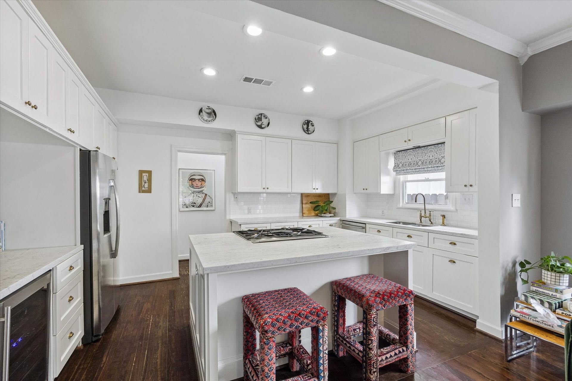 Stunning remodeled kitchen with stainless steel appliances, ample cabinet space and marble countertops