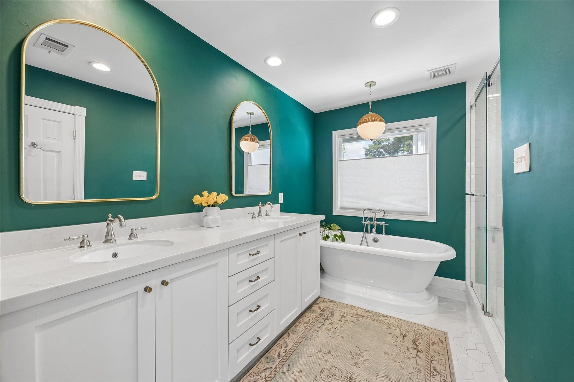Primary bathroom with double sinks, soaking tub, separate shower and private water closet