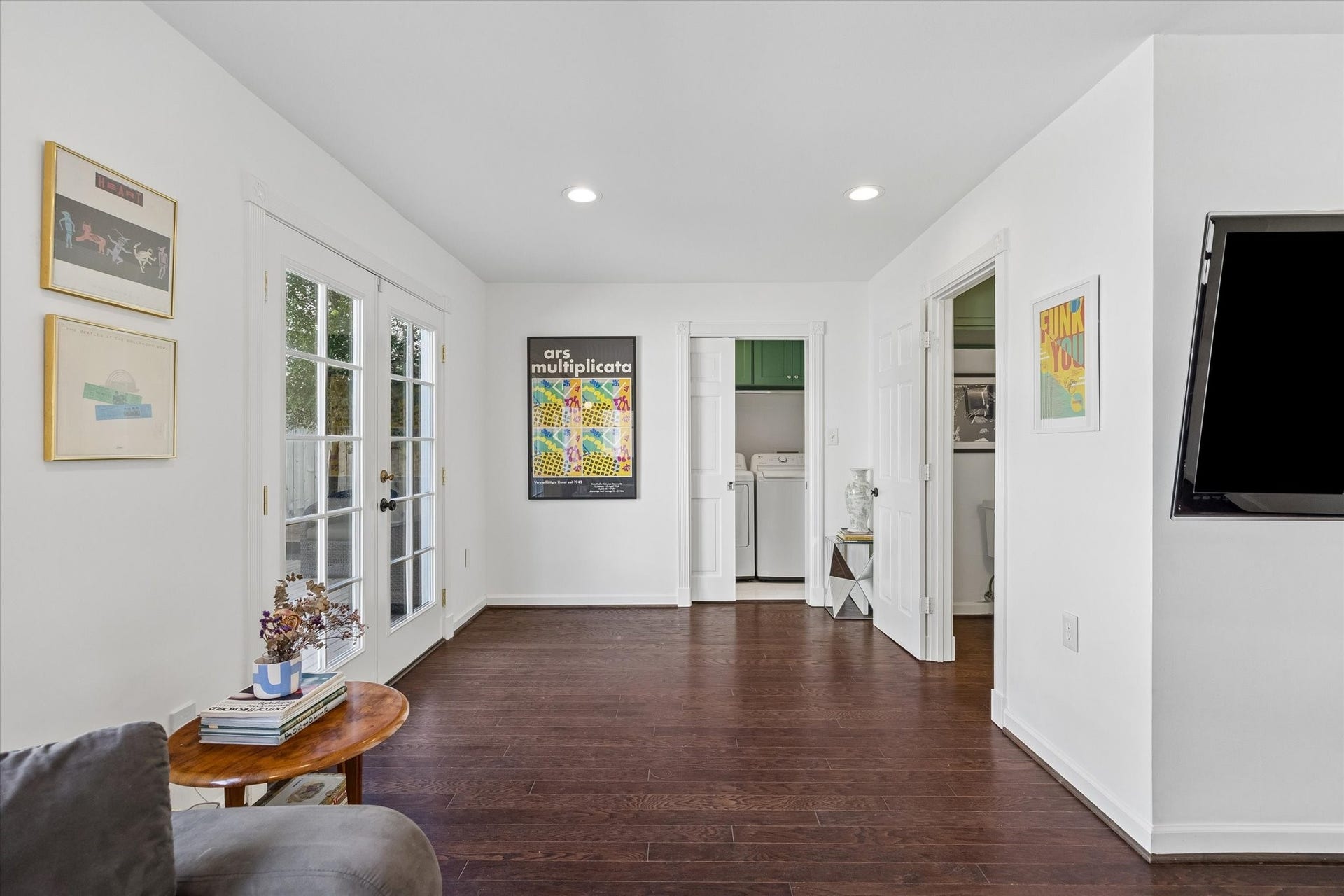 An angle of the room showcasing the laundry room and half bath