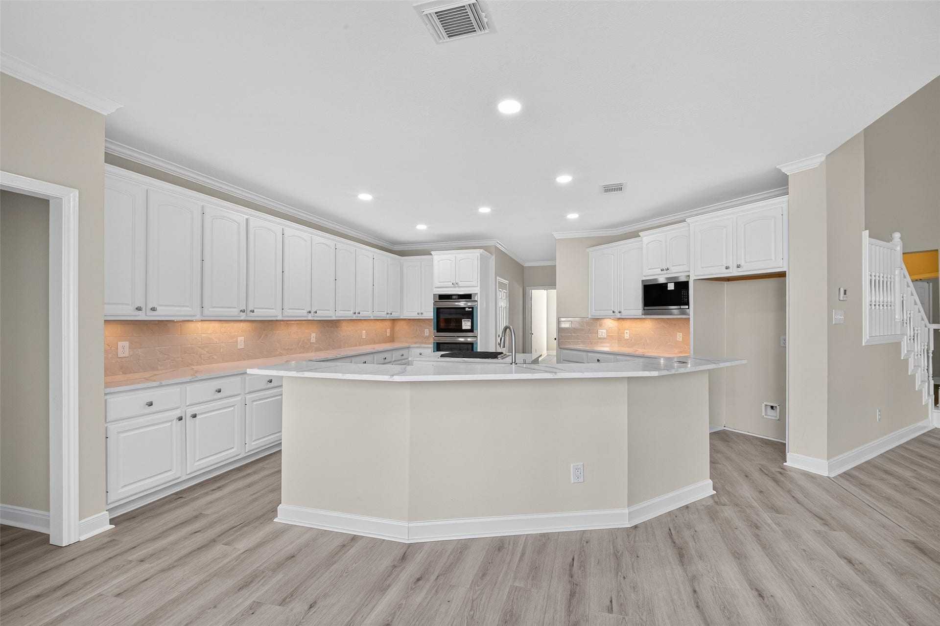 3610 Forest Row Drive, Houston, TX 77345 Brand New Kitchen! Expansive kitchen with a raised breakfast bar, extensive white cabinetry, double wall ovens, and a center cooking island. Recessed and under-cabinet lighting brighten the generous workspace.