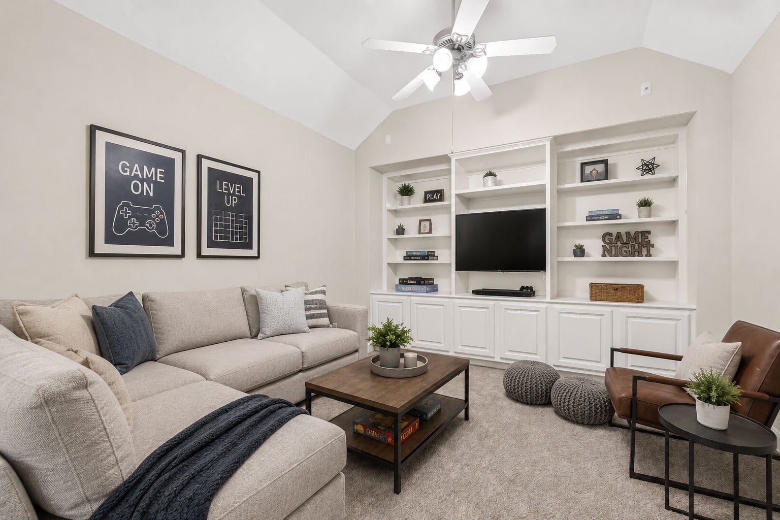 3610 Forest Row Drive, Houston, TX 77345 An inviting game room features a cozy sectional sofa, stylish armchairs, and built-in shelves with a TV, perfect for entertainment and relaxation. (Virtually staged)
