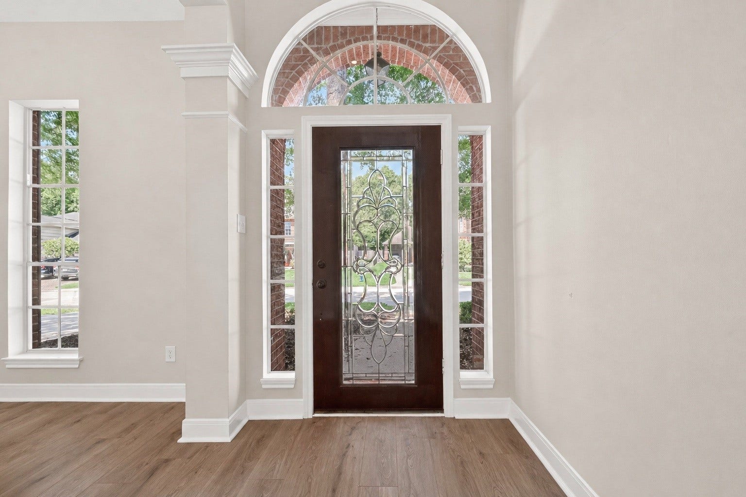 3610 Forest Row Drive, Houston, TX 77345 Elegant entryway featuring a beautifully crafted wooden door with decorative glass panels, complemented by large windows that flood the space with natural light.