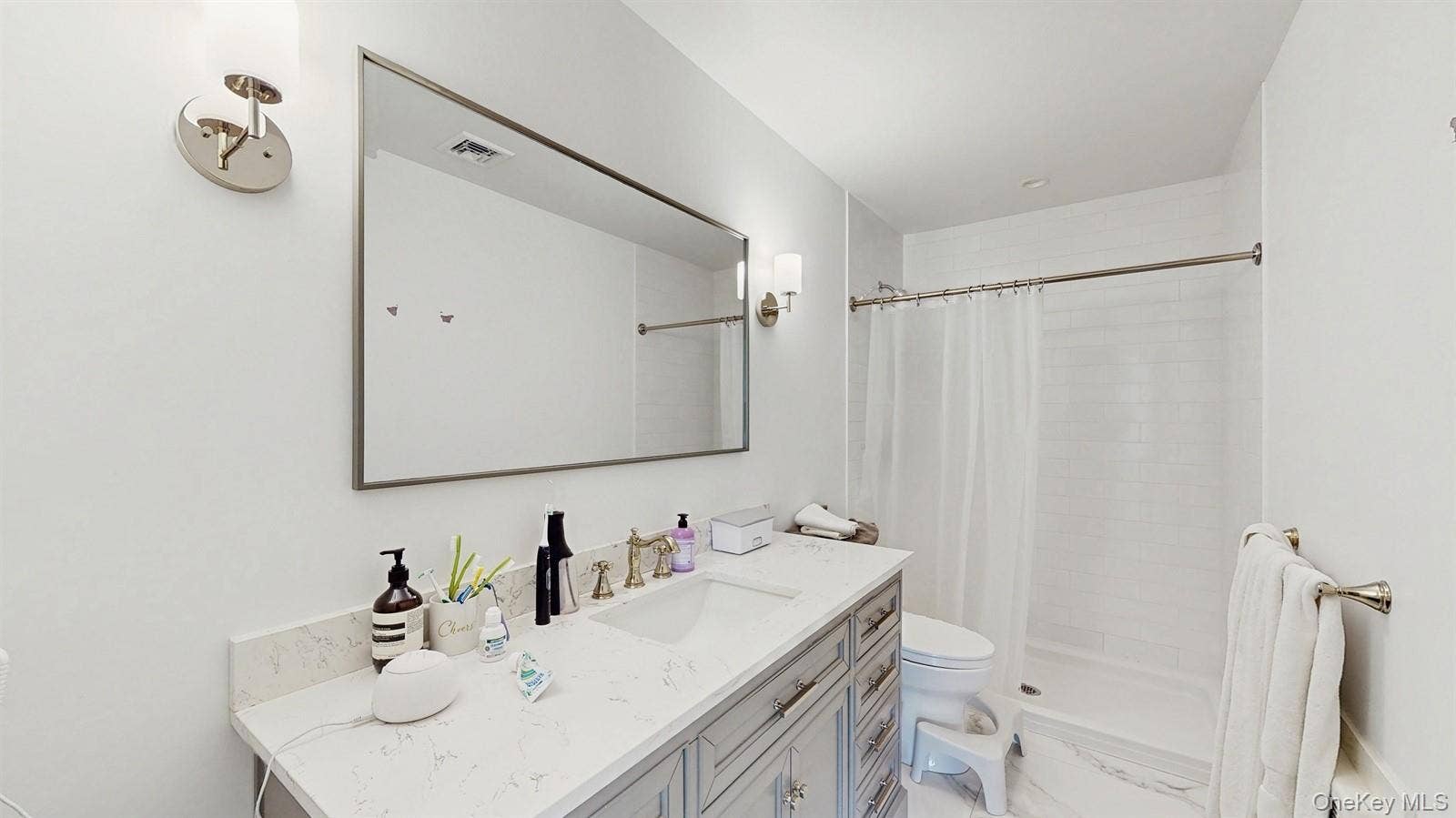 170 Wetherill Road, Garden City, NY 11530 Full bathroom featuring visible vents, toilet, tiled shower, and vanity