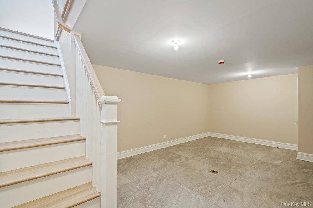89 Mill River Road, Upper Brookville, NY 11771 Below grade area featuring stairs and light marble finish floors