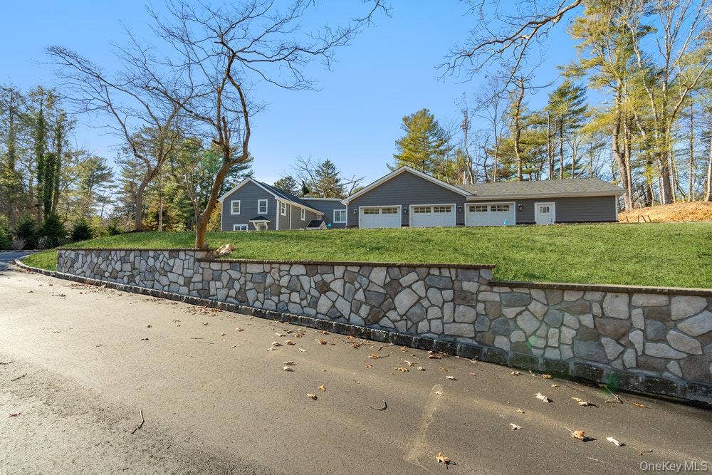 89 Mill River Road, Upper Brookville, NY 11771 View of front of property with a front lawn