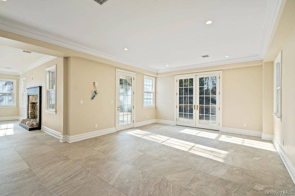 89 Mill River Road, Upper Brookville, NY 11771 Unfurnished room featuring french doors, recessed lighting, and crown molding