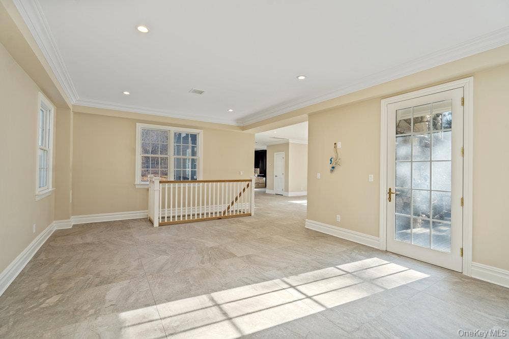 89 Mill River Road, Upper Brookville, NY 11771 Spare room featuring crown molding and recessed lighting