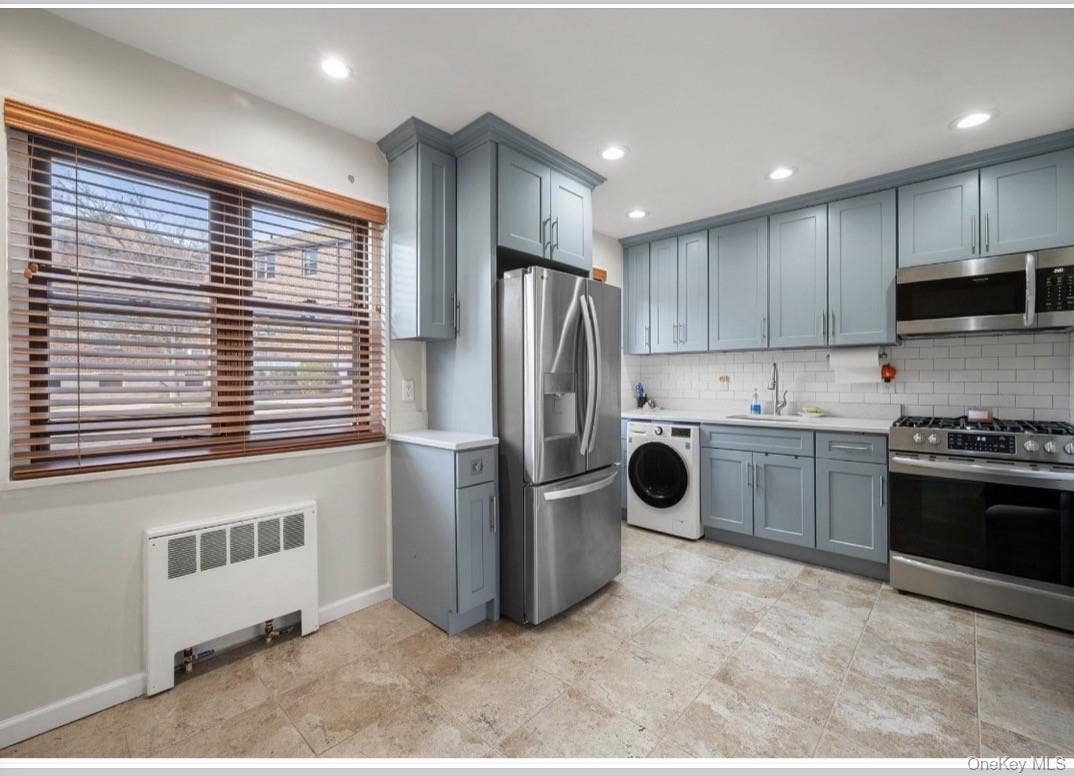 246-29 57th Drive, #B110, Douglaston, NY 11362 Renovated kitchen with new appliances and washer/dryer.