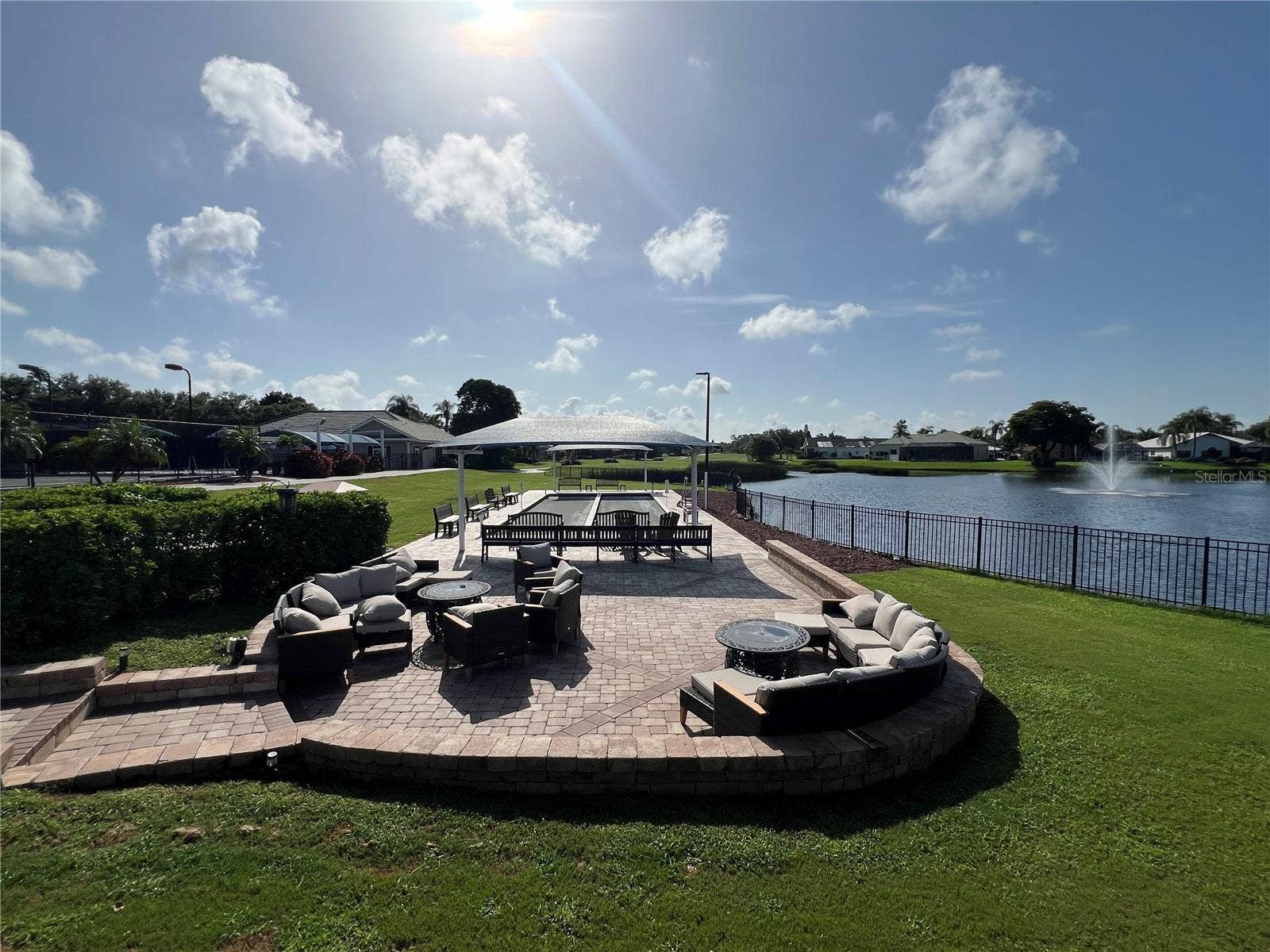 6713 STONE RIVER ROAD, #205, Bradenton, FL 34203 Shuffleboard and lounging area by the beautiful pond.