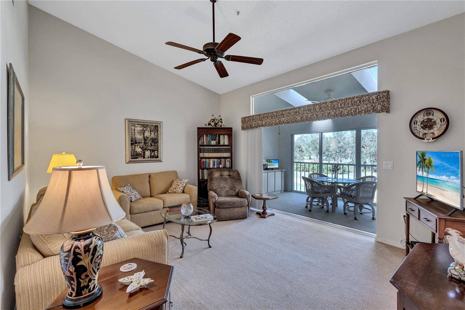6713 STONE RIVER ROAD, #205, Bradenton, FL 34203 Living Area with Pocket Sliders over looking the Fairway