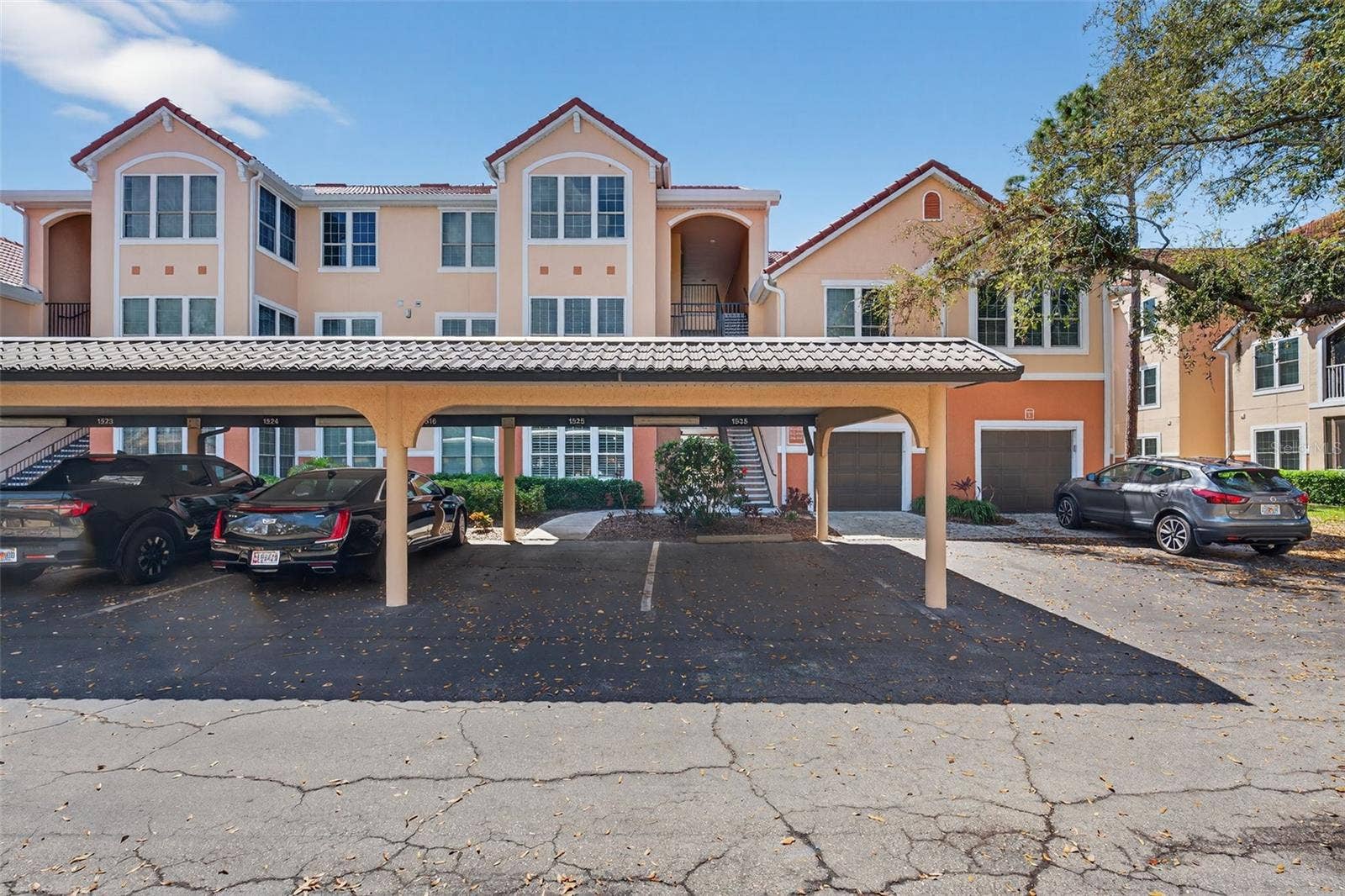 4138 CENTRAL SARASOTA PARKWAY, #1526, Sarasota, FL 34238 Front exposure of bldg 4138 with carports, detached garages and guest parking available