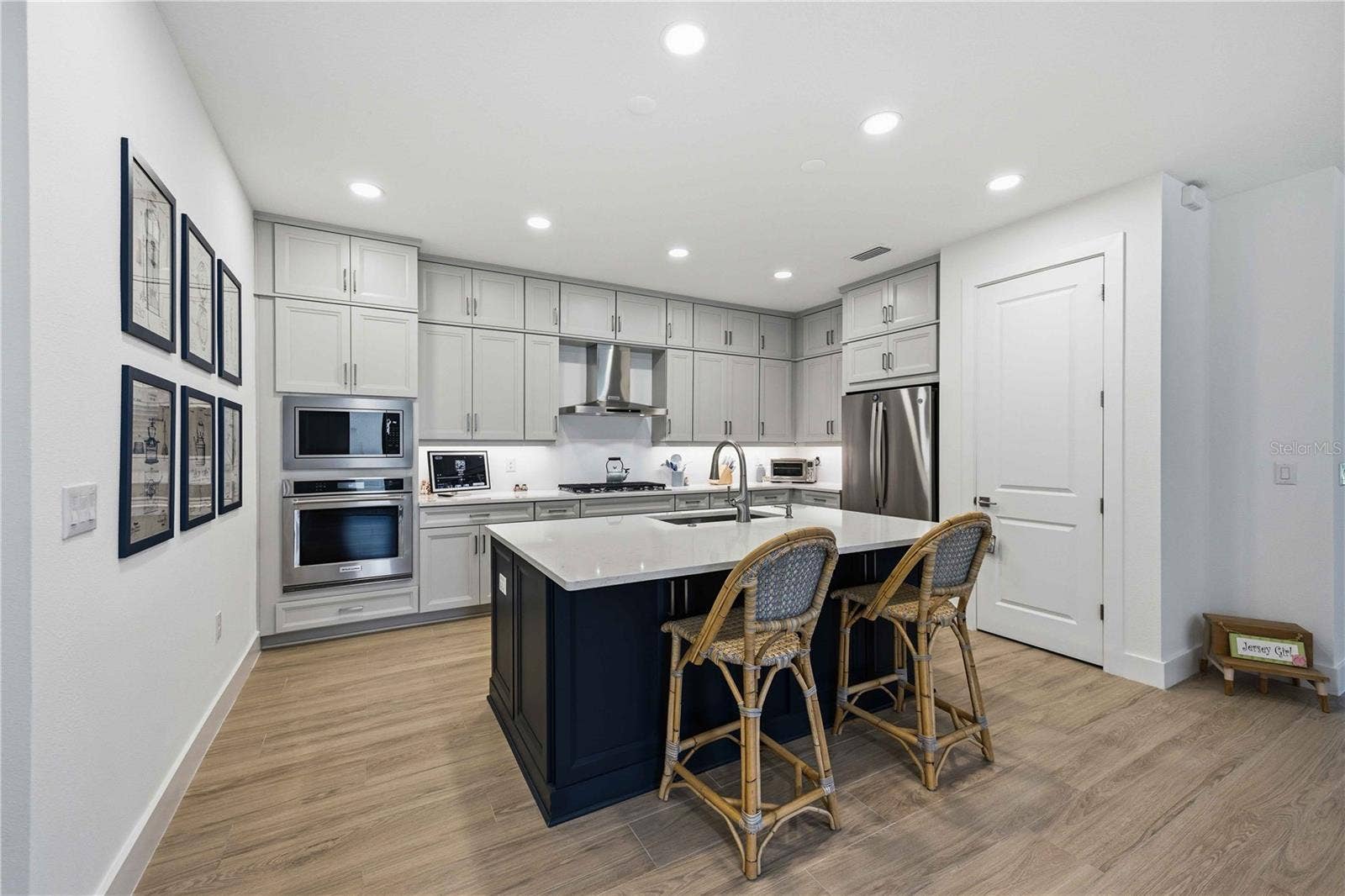 18652 DAYSPRING PLACE, Venice, FL 34293 Kitchen island and cabinetry view from the foyer.