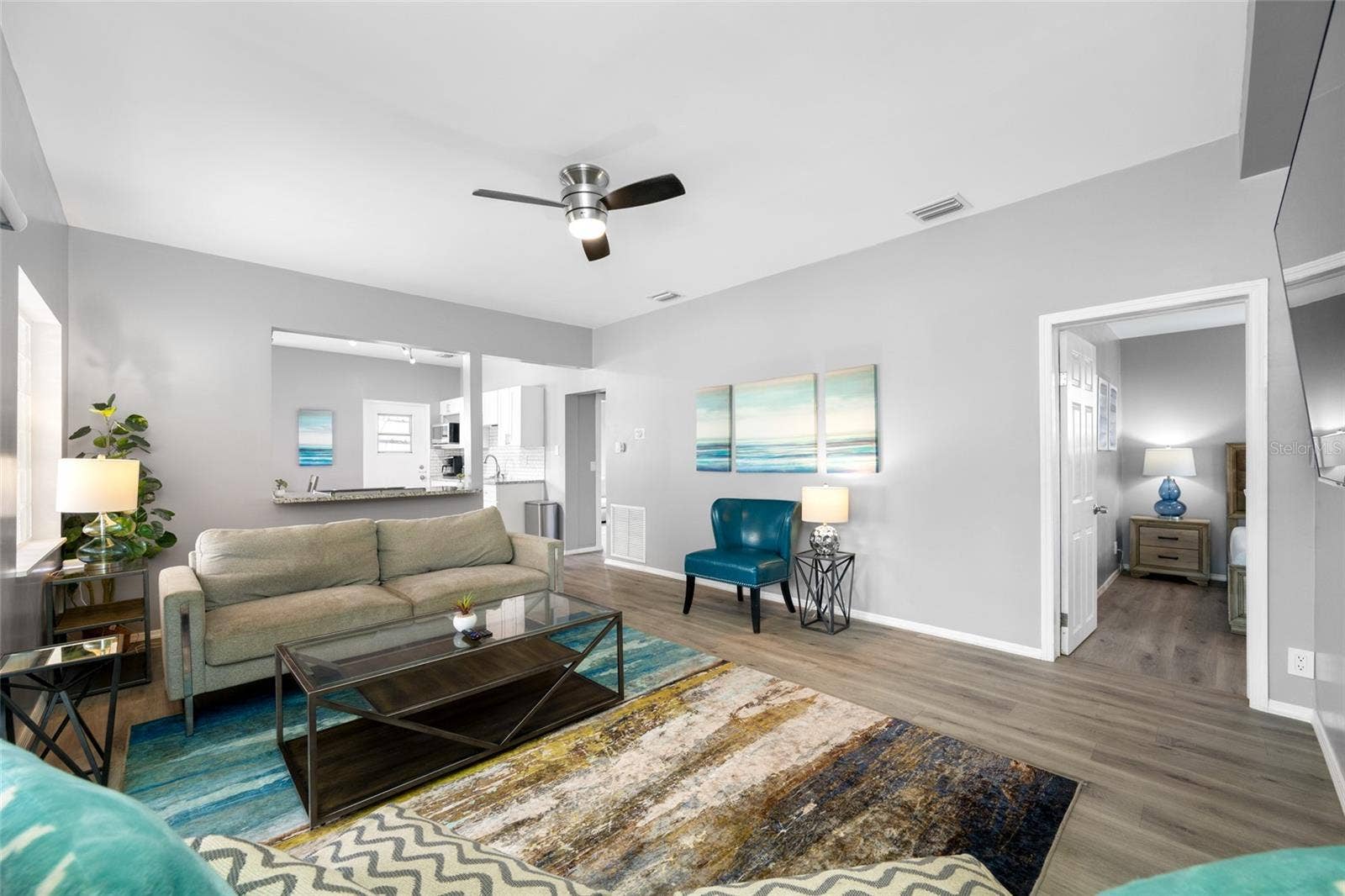 5044 BETTY STREET N, St Petersburg, FL 33709 Living Room with electric fireplace and sliding door to the front screened porch