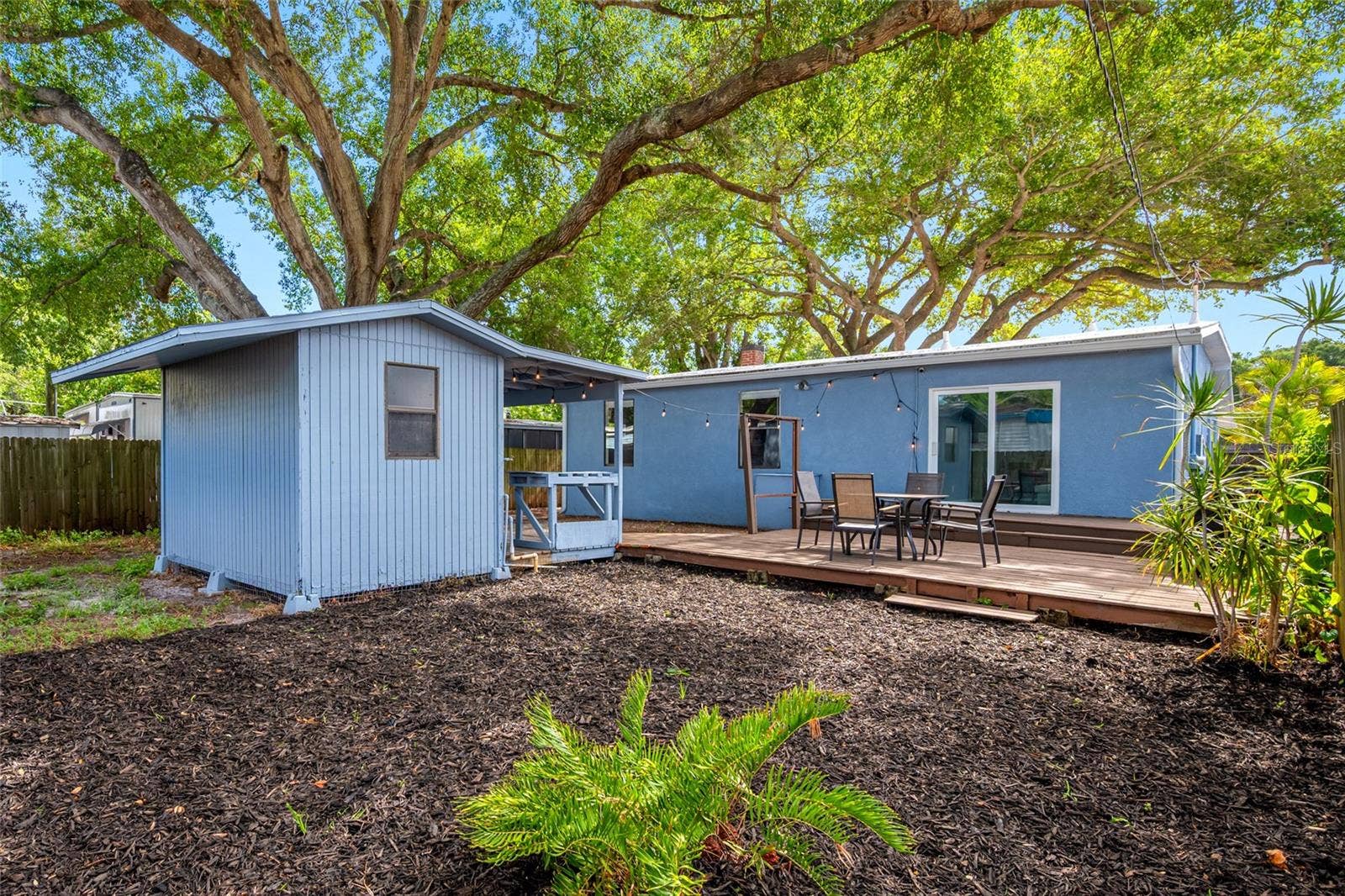 5044 BETTY STREET N, St Petersburg, FL 33709 Fenced in back yard with 20ft wide deck that leads to detached workshop and shed.