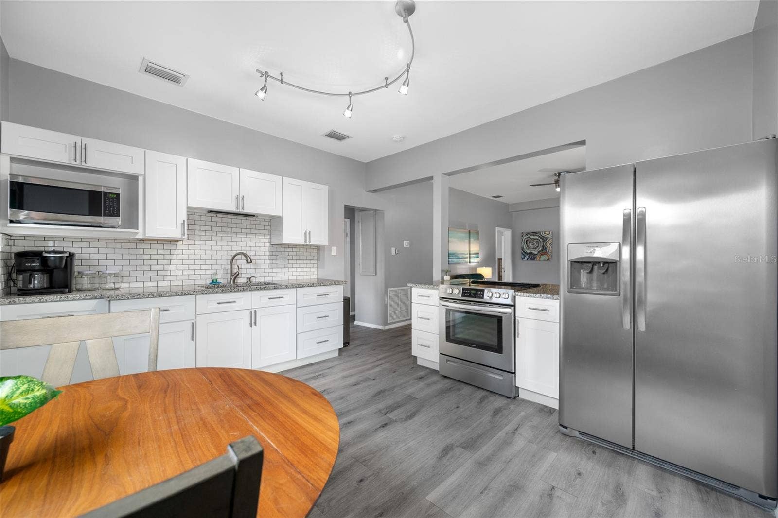 5044 BETTY STREET N, St Petersburg, FL 33709 Modern kitchen with granite counters & breakfast bar