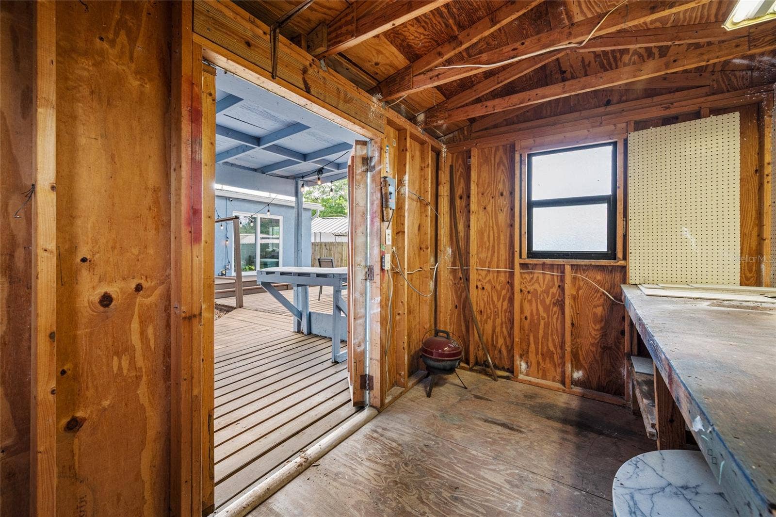 5044 BETTY STREET N, St Petersburg, FL 33709 detached workshop with built in desk, perfect for projects and hobbies