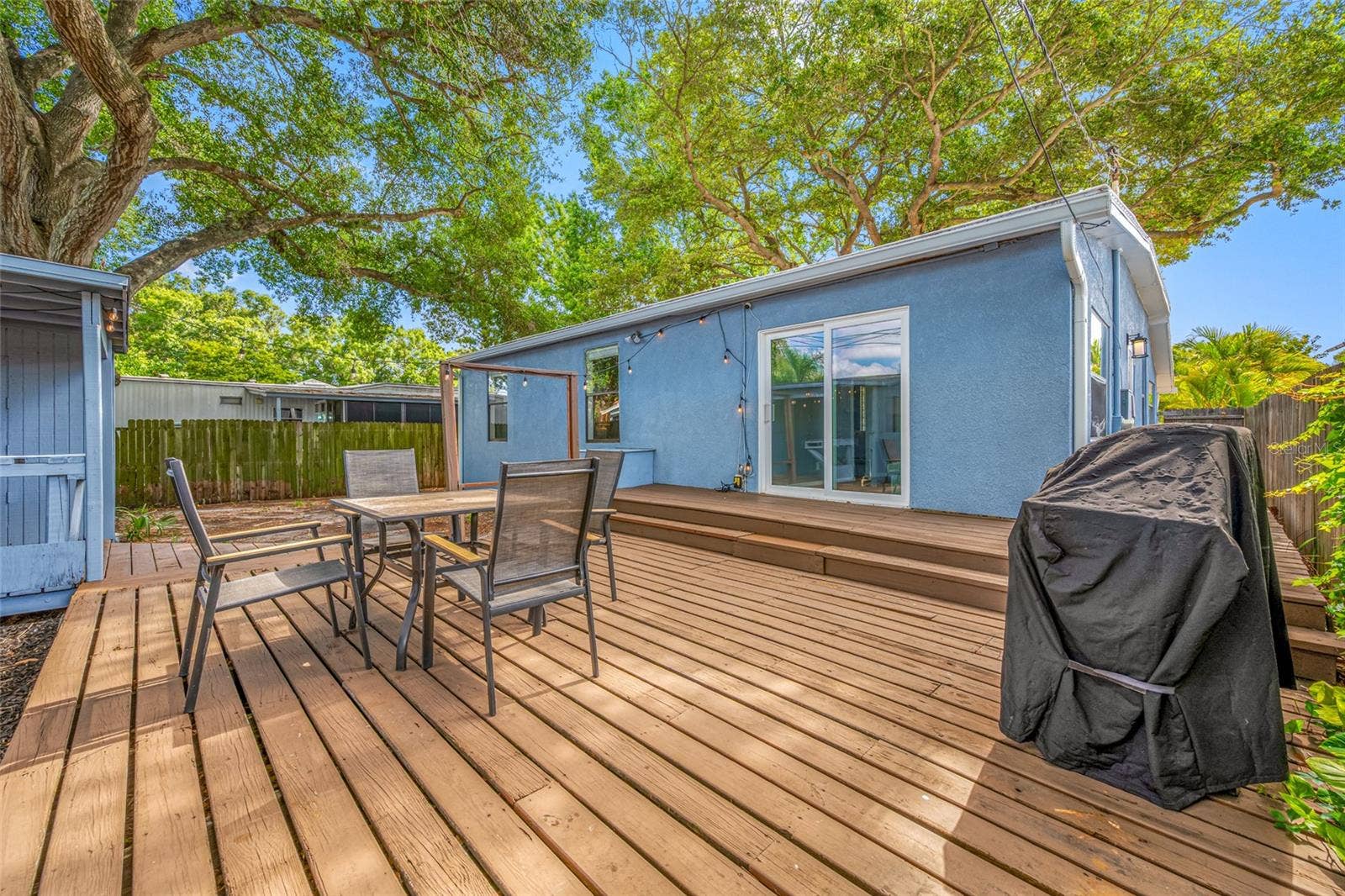 5044 BETTY STREET N, St Petersburg, FL 33709 Fenced in back yard with 20ft wide deck that leads to detached workshop and shed.