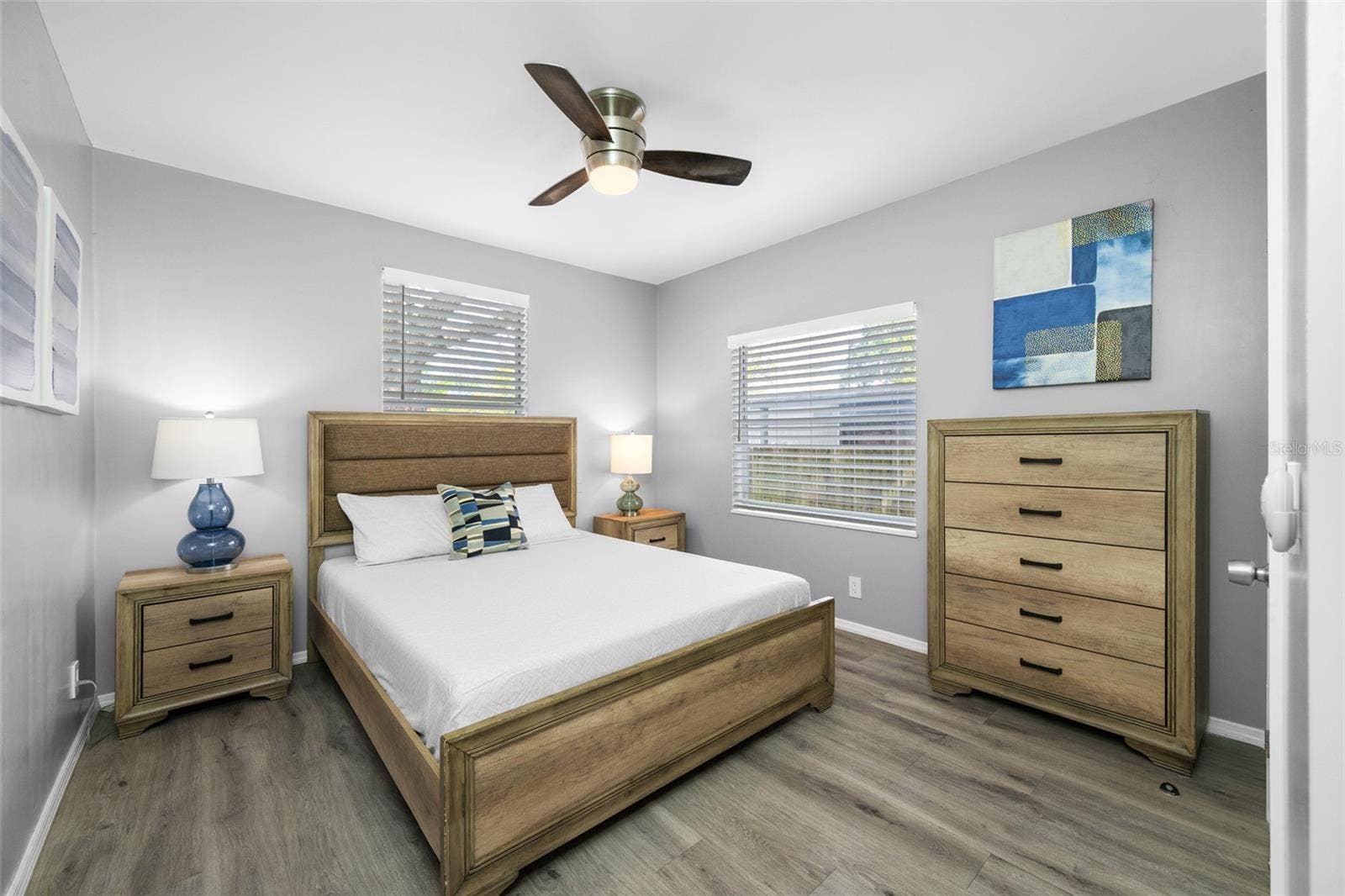 5044 BETTY STREET N, St Petersburg, FL 33709 Primary Bedroom suite with walk-in closet, with built in shevles, that opens through to private en-suite updated bathroom with marble tile and glass shower.