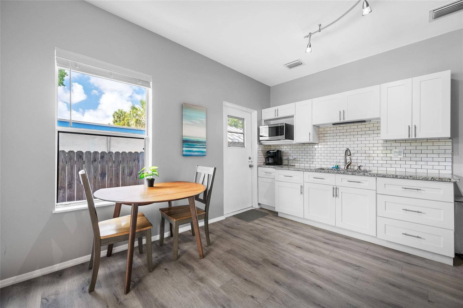 5044 BETTY STREET N, St Petersburg, FL 33709 Modern kitchen with granite counters & breakfast bar
