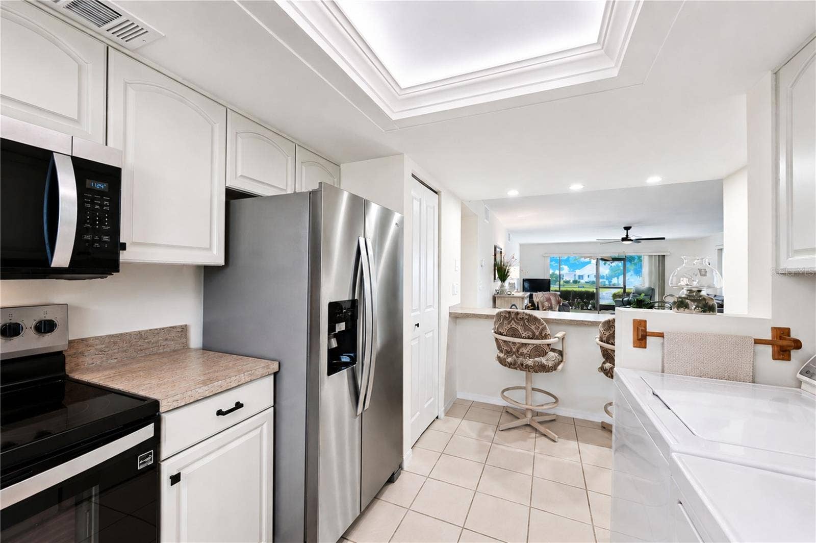 4853 INDEPENDENCE DRIVE, Bradenton, FL 34210 View from kitchen extends through the entertaining areas to the outdoors