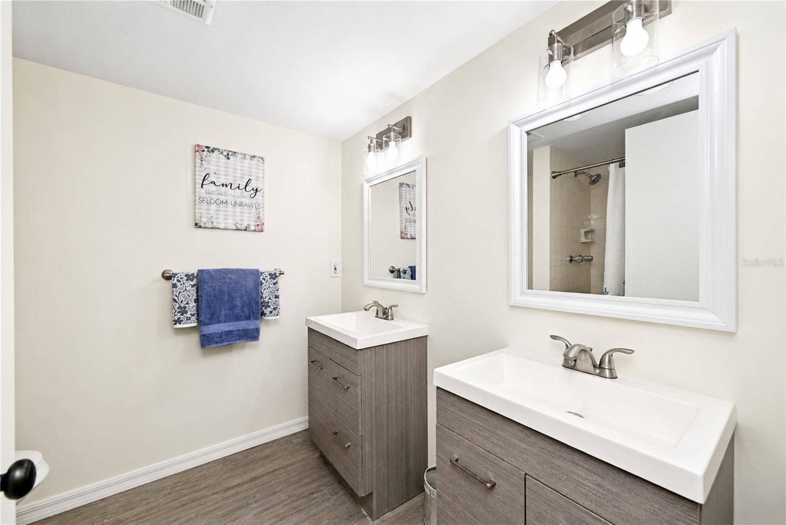 4853 INDEPENDENCE DRIVE, Bradenton, FL 34210 Primary bedroom's updated ensuite bathroom boasts dual vanities and a walk-in shower