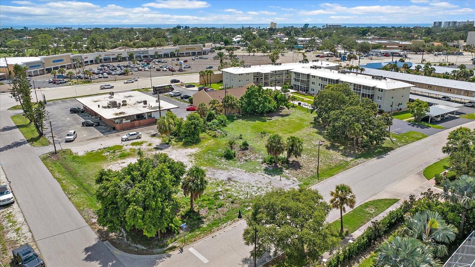 648 GUILD DRIVE, Venice, FL 34285 Aerial view of the lot facing the shopping plaza and nearby condominiums