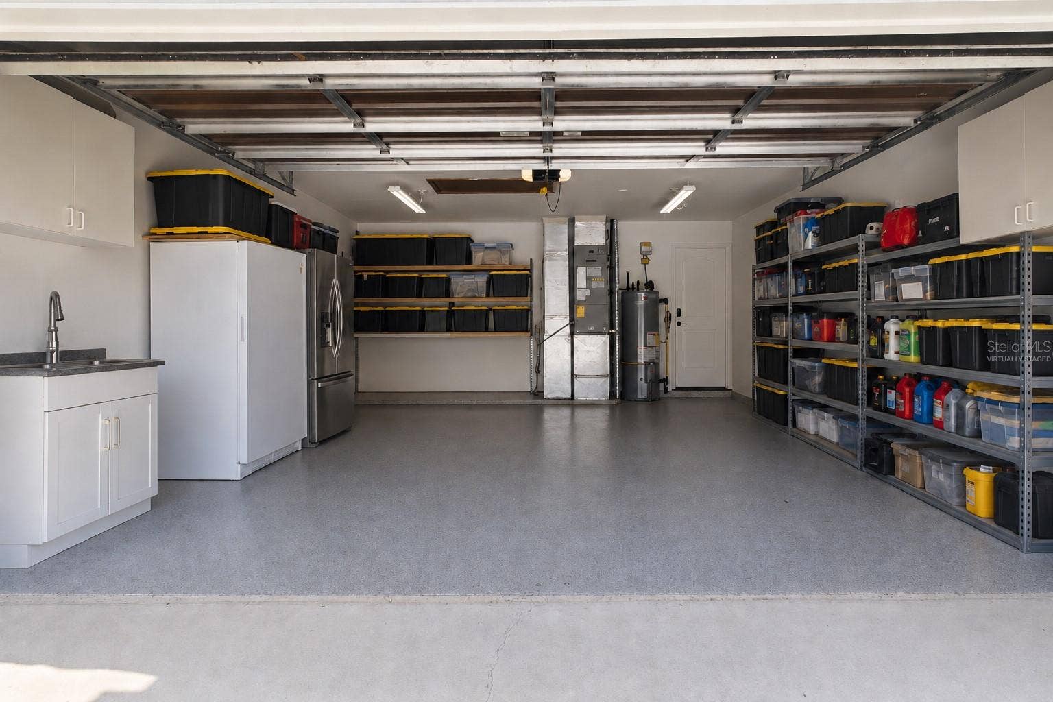 7905 55TH STREET E, Palmetto, FL 34221 2 CAR GARAGE W/UTILITY SINK - Some Storage Shelving has been Virtually Staged