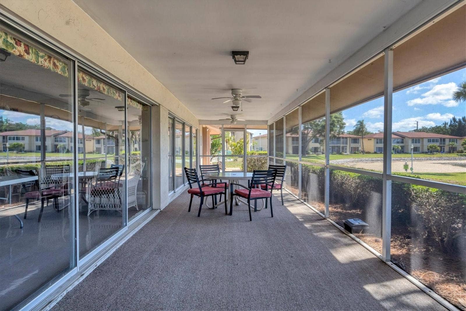 4538 PAWNEE TRAIL, #197, Sarasota, FL 34233 Clubhouse covered lanai overlooks large lake