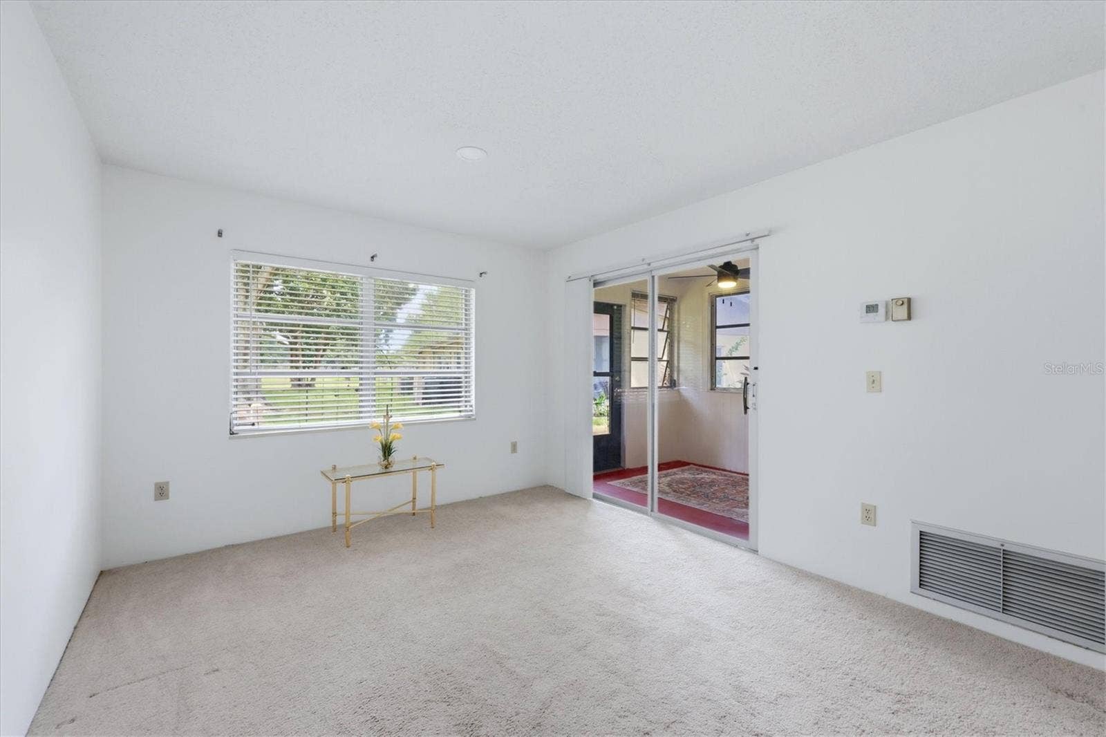 4538 PAWNEE TRAIL, #197, Sarasota, FL 34233 Living room area opens to covered porch