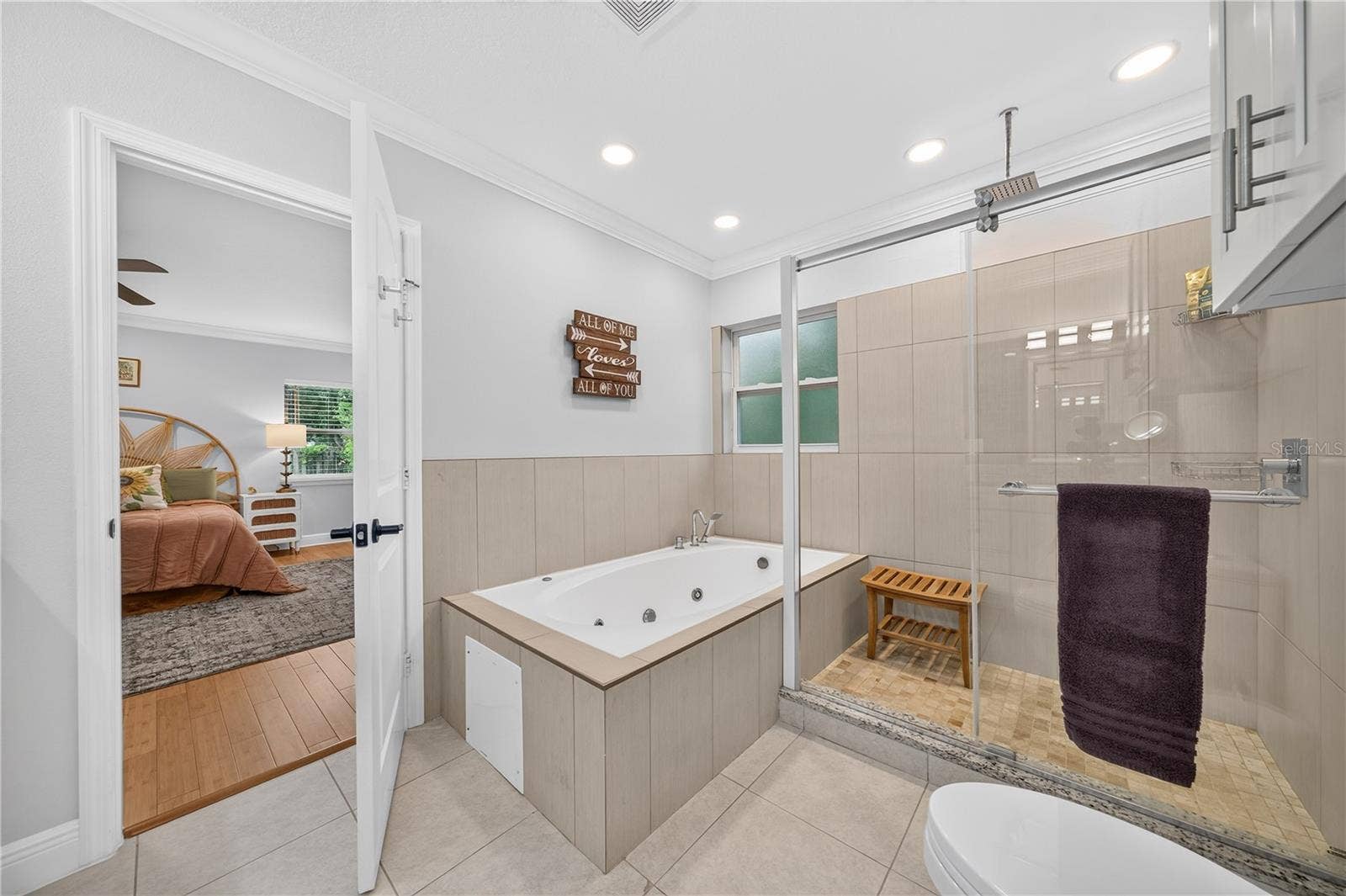 large jetted tub and step in shower with rainhead