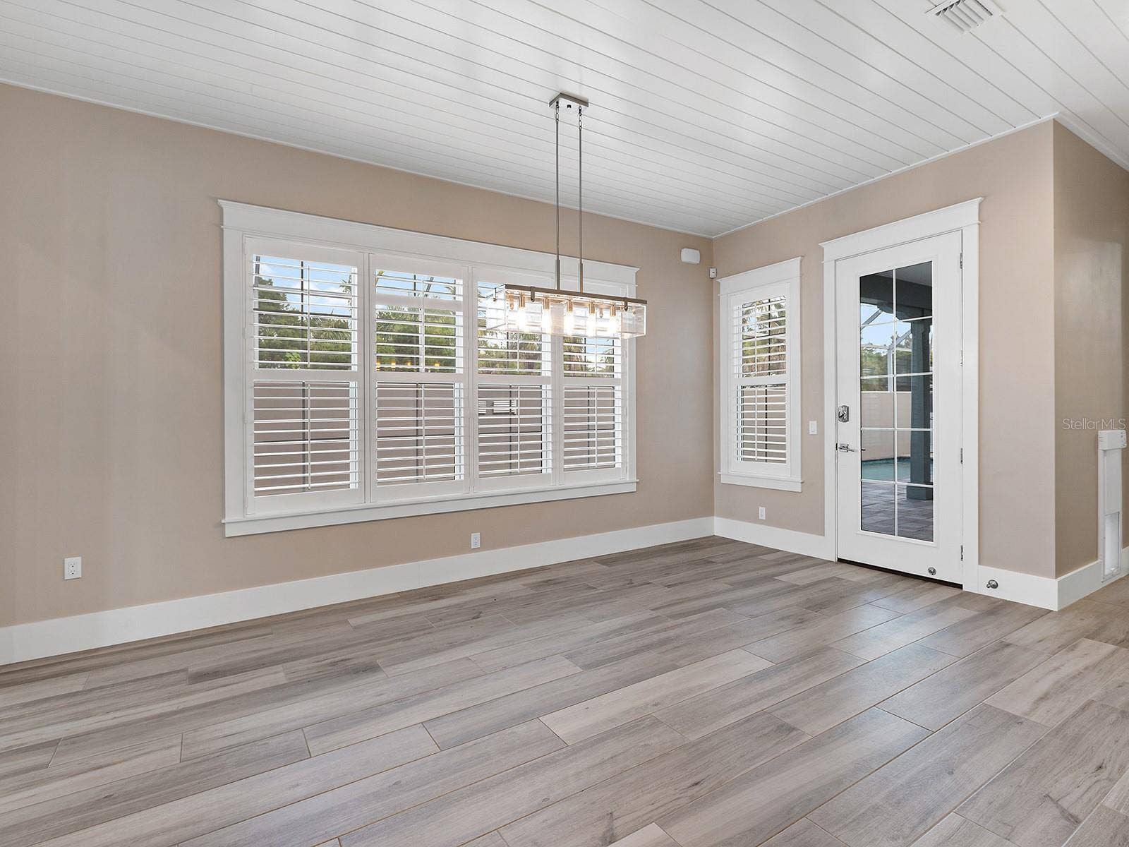 4024 11TH STREET COURT W, Palmetto, FL 34221 Dining space with a view of the expansive pool deck