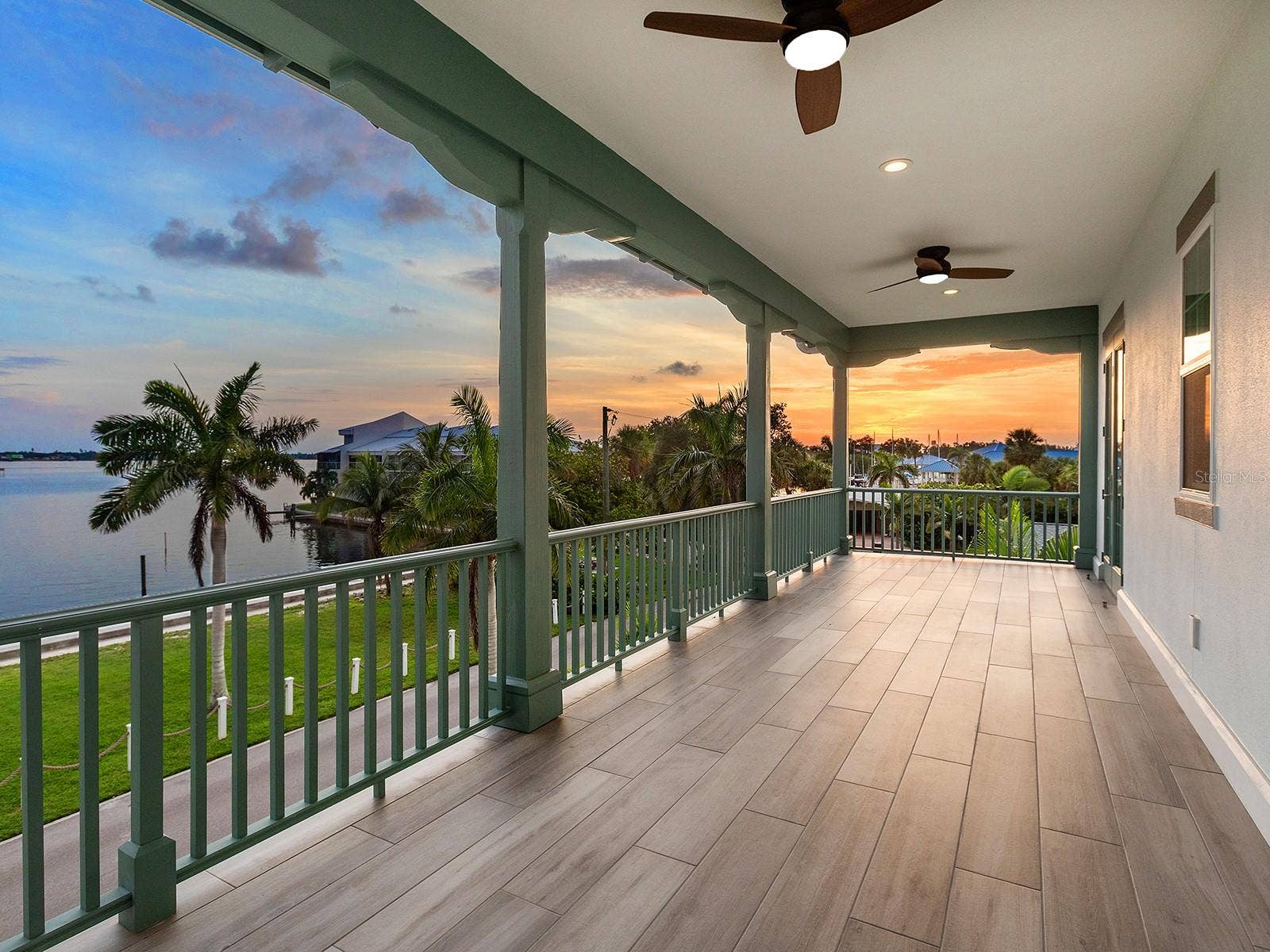 4024 11TH STREET COURT W, Palmetto, FL 34221 Second-floor primary suite balcony offering Manatee River sunset views. Imagine planning your next boat from here.