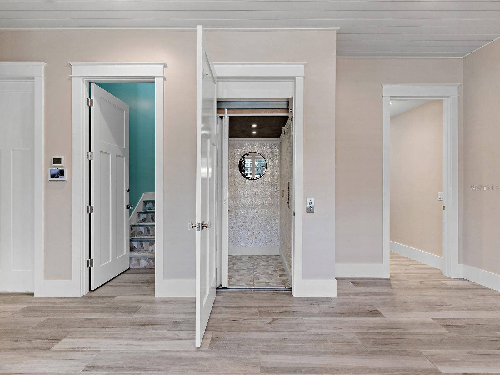 4024 11TH STREET COURT W, Palmetto, FL 34221 Tiled, accessible elevator next to a staircase to the second floor