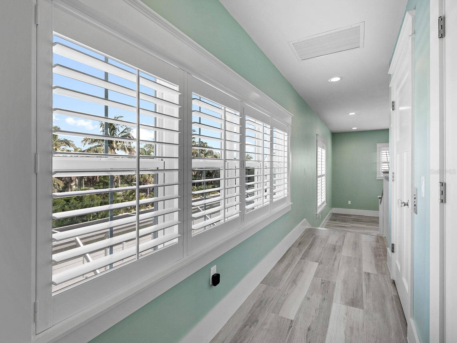 4024 11TH STREET COURT W, Palmetto, FL 34221 Hallway from the second-floor den and primary suite with elevator on right