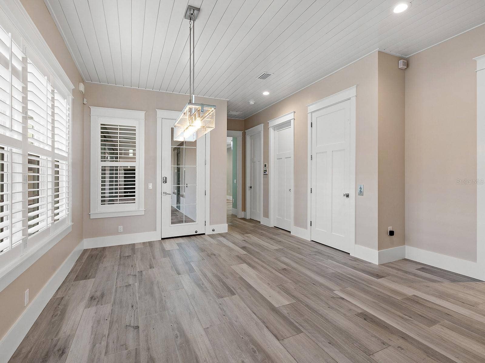 4024 11TH STREET COURT W, Palmetto, FL 34221 Flow through the dining space under the chandelier to your ground floor primary suite and dedicated laundry room on the right