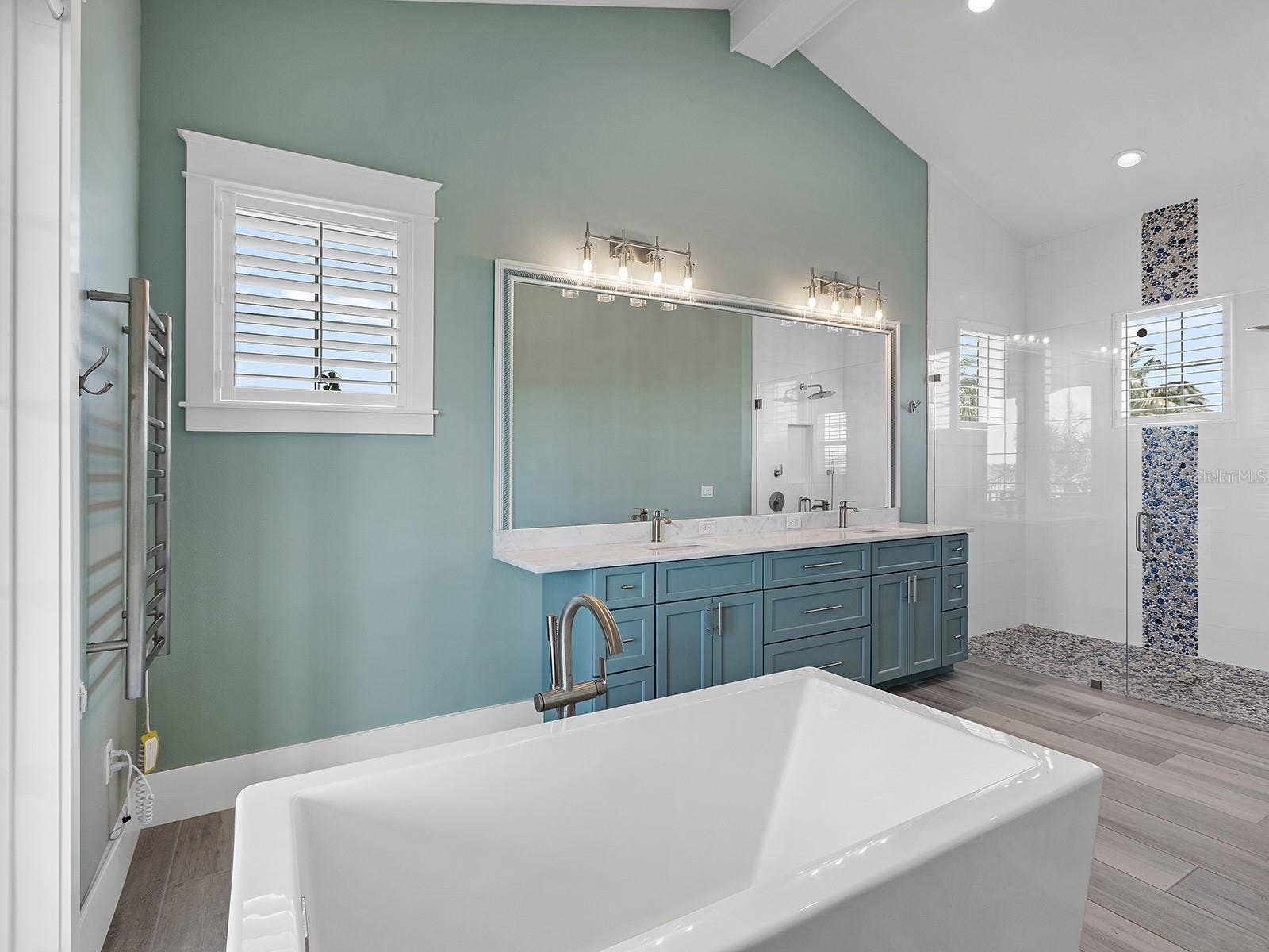 4024 11TH STREET COURT W, Palmetto, FL 34221 Spa-inspired primary ensuite featuring a freestanding soaking tub positioned to take in quiet river views, double vanity, and a walk-in pebble-tile shower
