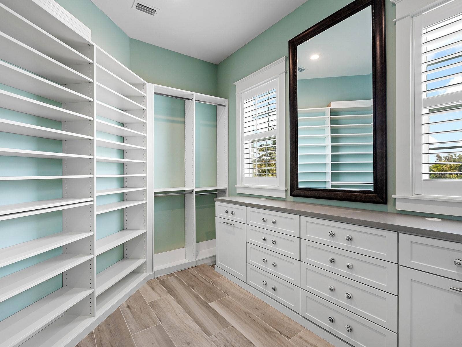 4024 11TH STREET COURT W, Palmetto, FL 34221 Spacious primary walk-in closet featuring custom built-ins and rich natural light