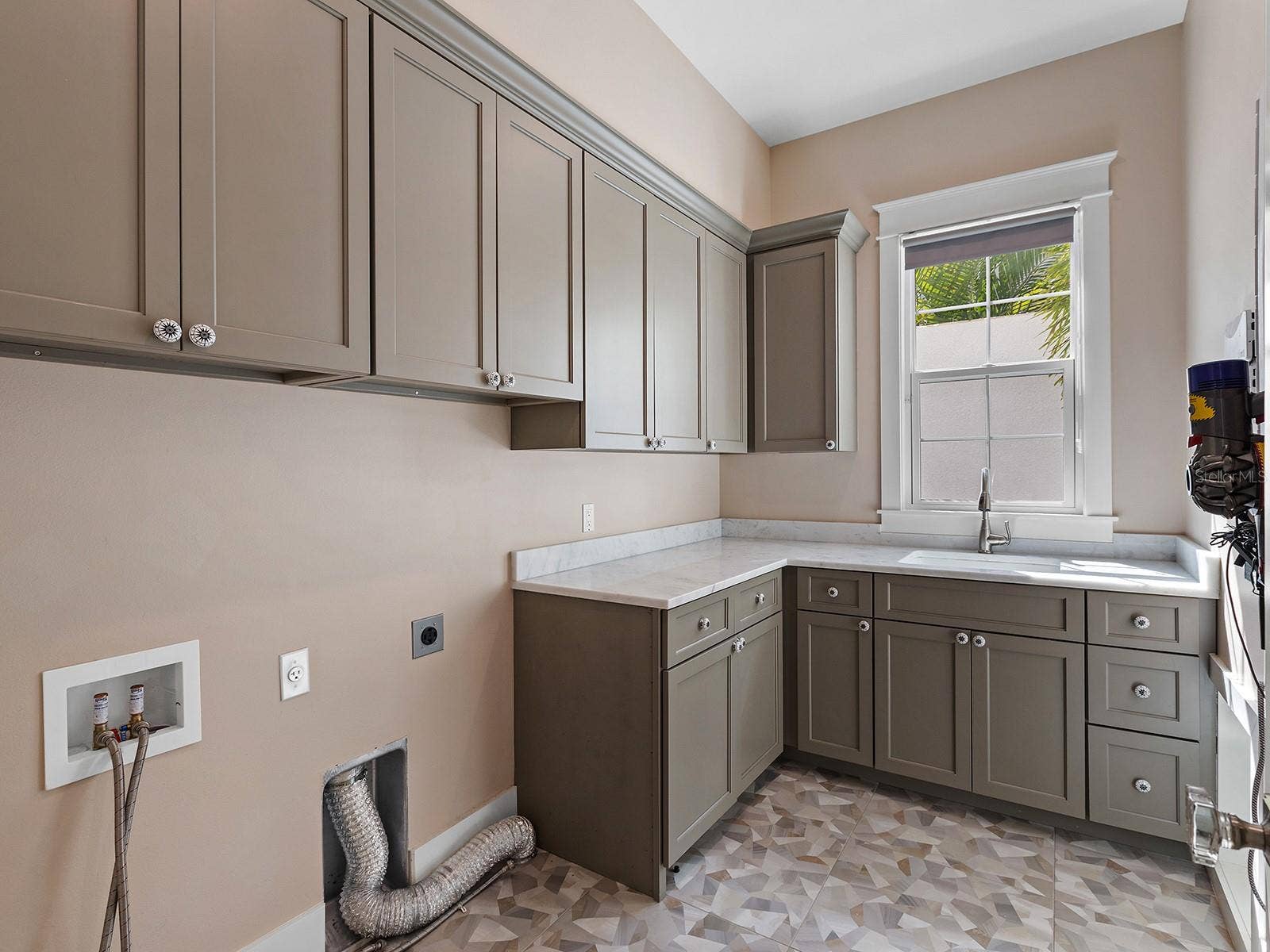 4024 11TH STREET COURT W, Palmetto, FL 34221 Ground floor laundry room adjacent to the staircase