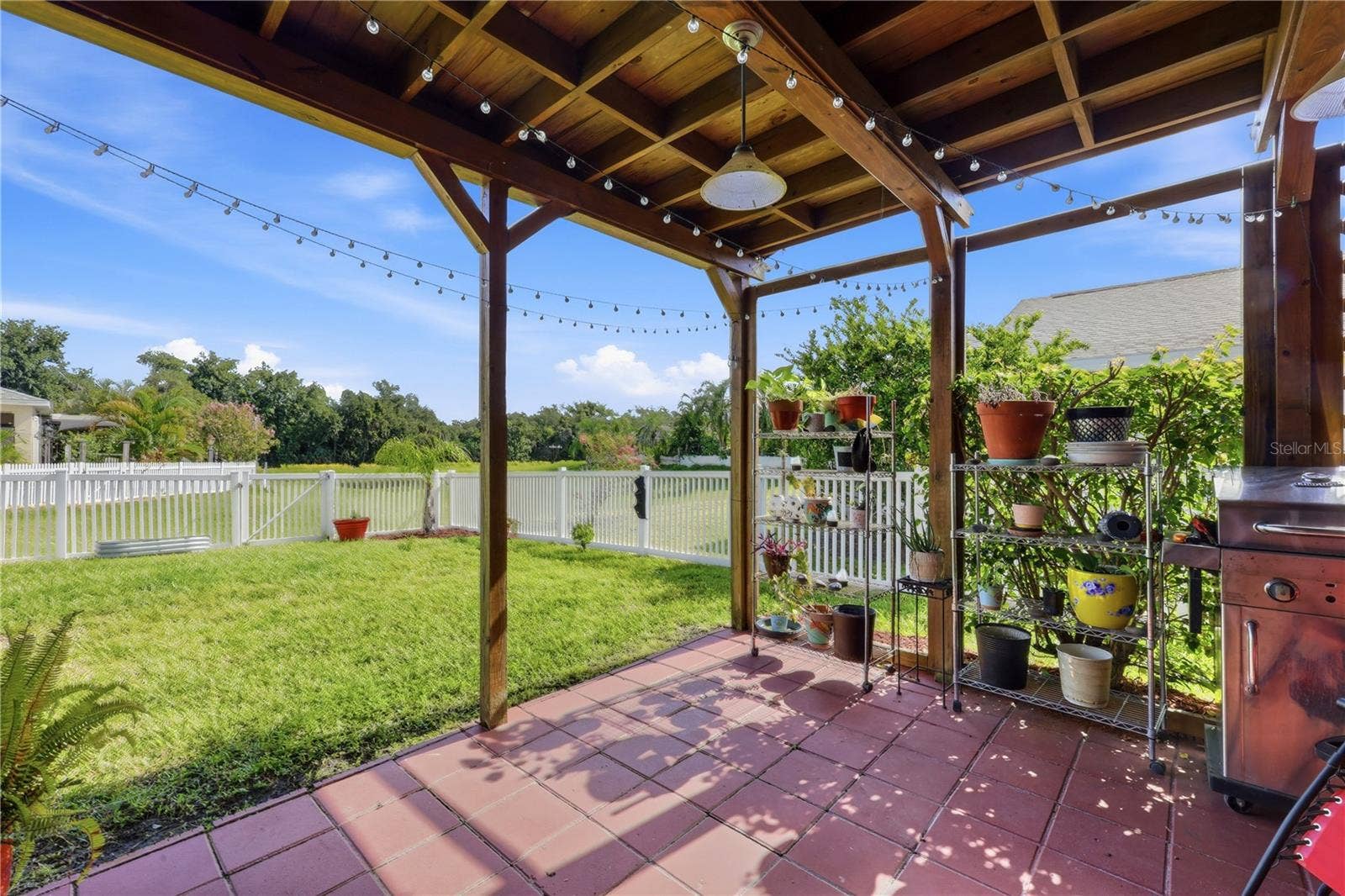 5310 72ND STREET E, Palmetto, FL 34221 Lovely Covered Terrace with view of the lake and fenced yard