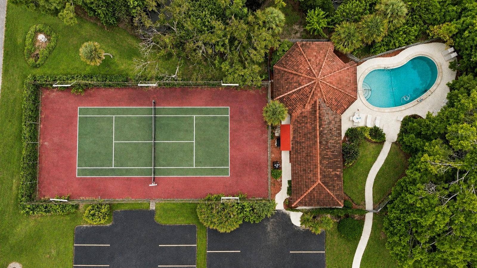 7500 40TH AVENUE W, #105, Bradenton, FL 34209 Aerial view of Tennis Court, Pool, and Clubhouse