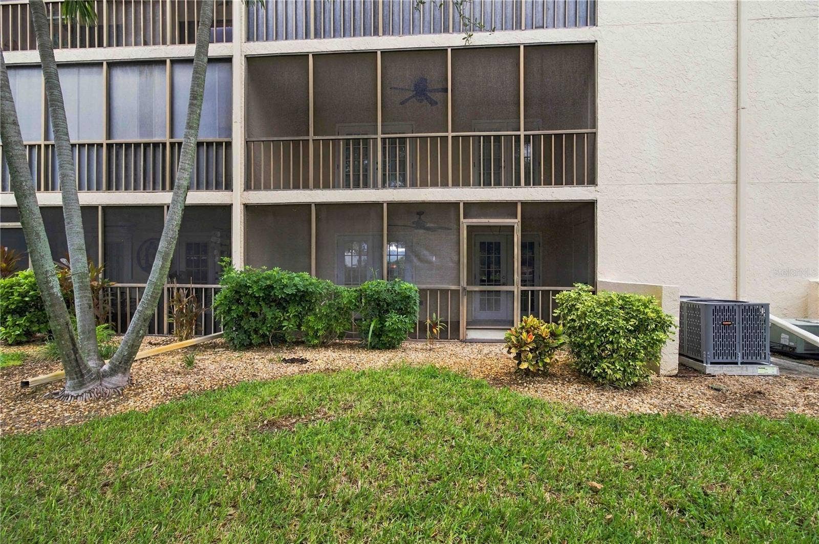 7500 40TH AVENUE W, #105, Bradenton, FL 34209 Exterior looking toward lanai from yard.