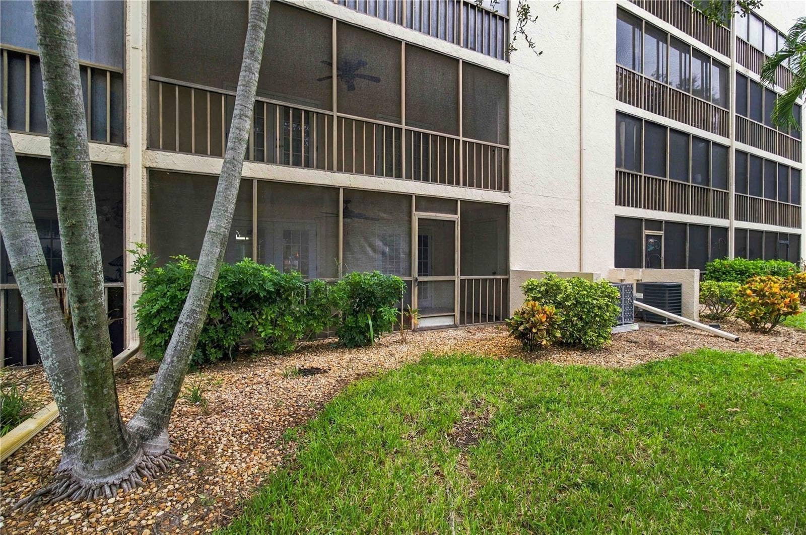 7500 40TH AVENUE W, #105, Bradenton, FL 34209 Exterior looking toward lanai from yard.